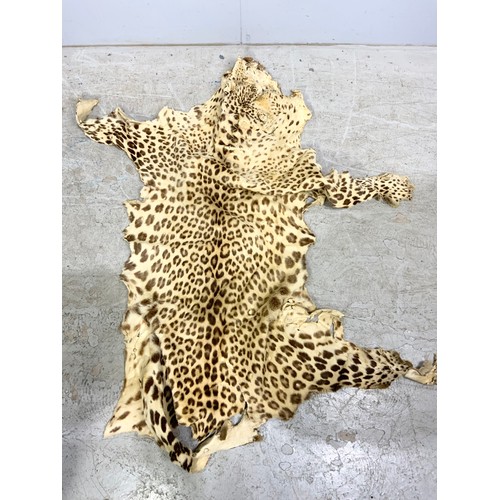 193 - TWO CHEETAH SKINS, A CHEETAH SKIN HANDBAG AND A HAT A/F