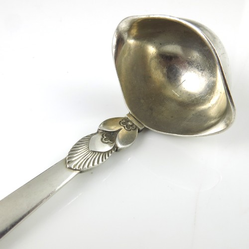 262 - DESIGNED BY GUNDORPH ALBERTUS FOR GEORG JENSEN, A DANISH SILVER CACTUS PATTERN SAUCE LADLE, APPROX. ... 