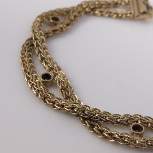 567 - 9CT GOLD AND RED STONE BRACELET, APPROX. 11g