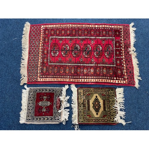 690 - RED GROUND RUG APPROX. 100 X 64 cm AND 2 SMALLER DITTOS