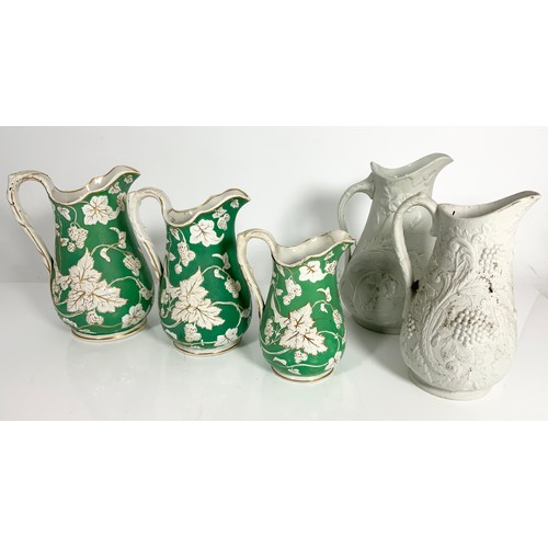 138 - GRADUATED SET OF THREE RELIEF DECORATED JUGS EACH WITH REGISTERED DESIGN MARKED TO THE BASE, GREEN, ... 