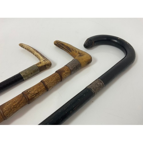 374 - 2 WALKING STICKS WITH SILVER MOUNTS AND AN ANTLER HANDLED RIDING CROP