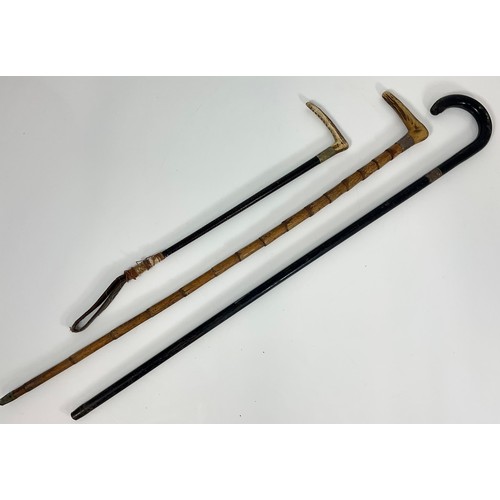 374 - 2 WALKING STICKS WITH SILVER MOUNTS AND AN ANTLER HANDLED RIDING CROP