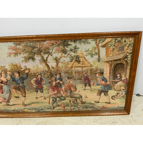 63 - OAK FRAMED TAPESTRY DEPICTING DUTCH SCENE 107cm x 54cm