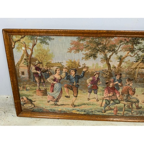 63 - OAK FRAMED TAPESTRY DEPICTING DUTCH SCENE 107cm x 54cm