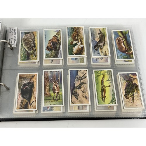 118 - A CIGARETTE CARD ALBUM CONTAINING 26 SETS OF ORIGINAL CARDS, MOSTLY G/VG, CATALOGUE £490+