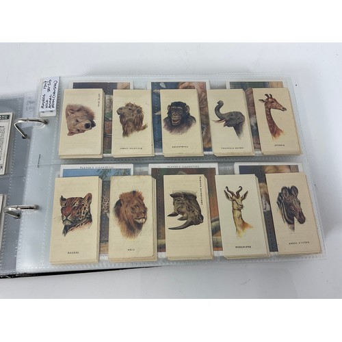 121 - A CIGARETTE CARD ALBUM CONTAINING 25 SETS OF ORIGINAL CARDS, MOSTLY G/VG, CATALOGUE £510+