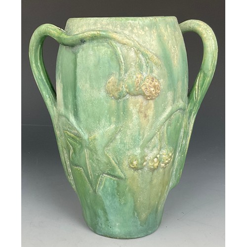 166 - UNUSUAL GREEN GROUND VASE WITH 2 SINUOUS HANDLES AND RELIEF FRUIT AND BRANCH DECORATION, INDISTING I... 