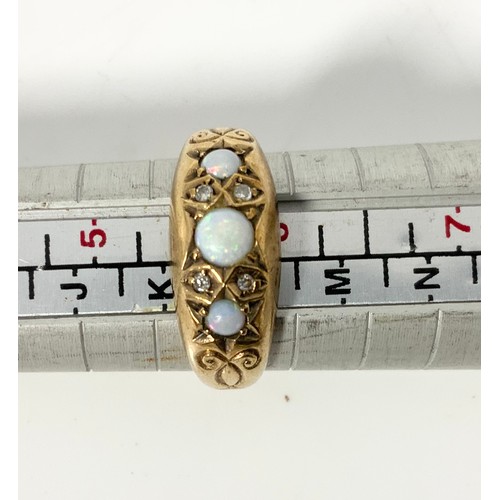 633 - 18CT GOLD RING SET WITH 3 OPALS EACH SEPARATED BY 2 SMALL DIAMONDS