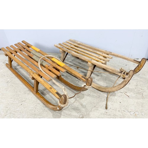 476 - TWO VINTAGE WOODEN SLEDGES WITH METAL RUNNERS