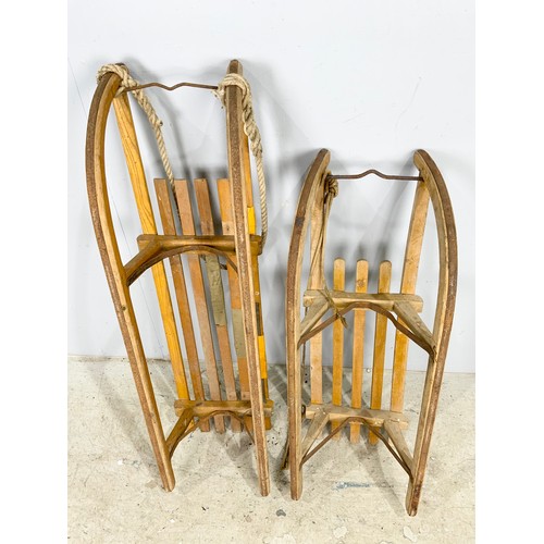 476 - TWO VINTAGE WOODEN SLEDGES WITH METAL RUNNERS