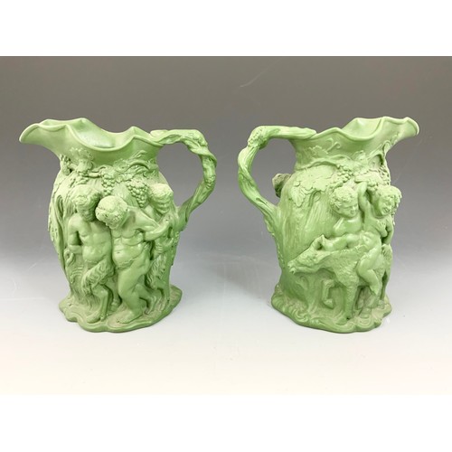 137 - PAIR OF 19TH CENTURY GREEN BACCHUS JUGS, MOULDED 19 BACKSTAMP 23cm TALL