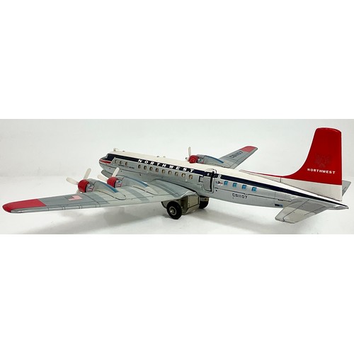 61 - NORTHWEST DOUGLAS DC-7C BIG TIN FRICTION AEROPLANE. BATTERY-OP. CRAGSTAN/YONEZAWA. 23.5