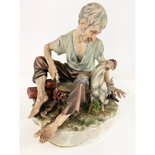 96 - 2 LARGE CAPODIMONTE FIGURINES  TRAMP ON BENCH &  MAN FRYING ON OPEN FIRE TALLEST 24cm