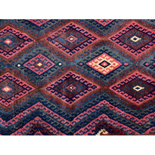 1049 - RED GROUND RUG WITH GEOMETRIC PATTERN 234cm x 132cm