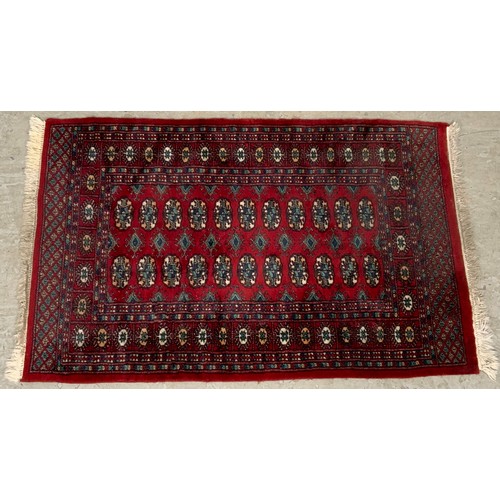 1057 - RED GROUND RUG 146cm x 95cm