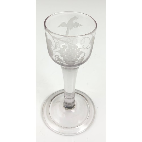 76 - 18TH DRINKING GLASS HAVING AN OGEE BOWL WITH ENGRAVED VINE LEAF DECORATION ON A PLAIN STEM WITH FOLD... 