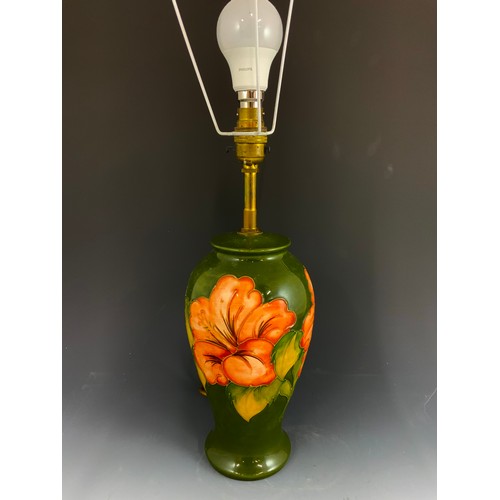 55 - LARGE MOORCROFT POTTERY TABLE LAMP IN THE HIBISCUS PATTERN ON GREEN GROUND