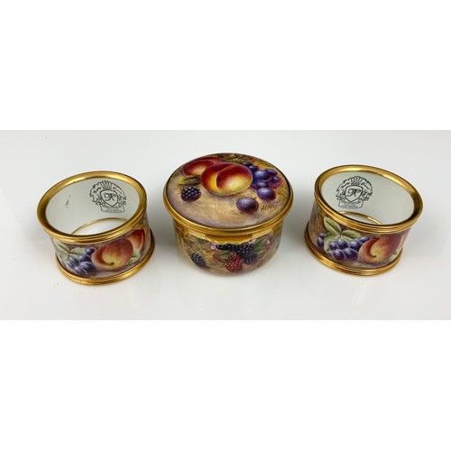 41 - KINGSLEY ENAMELS POT WITH COVER PAINTED STILL LIFE FRUIT AND TWO SERVIETTE RINGS