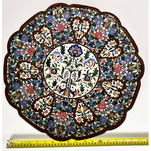 222 - CONTINENTAL RELIEF DECORATED CHARGER WITH HAND PAINTED CENTRAL PANEL DECORATED WITH FLORAL SPRAY, IM... 