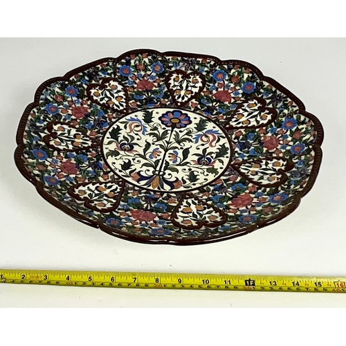 222 - CONTINENTAL RELIEF DECORATED CHARGER WITH HAND PAINTED CENTRAL PANEL DECORATED WITH FLORAL SPRAY, IM... 