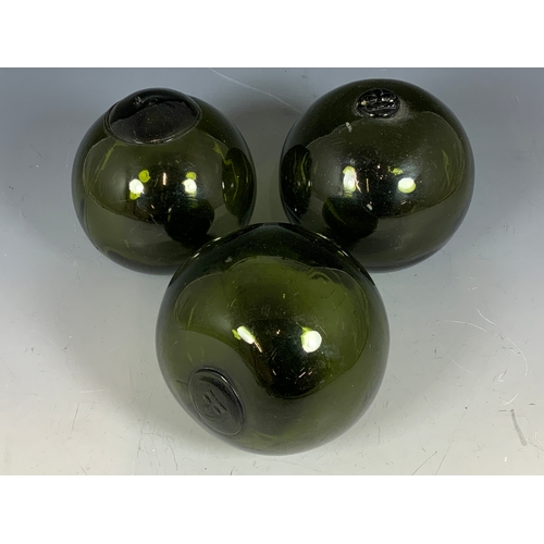 331 - 3 GREEN GLASSS FLOATS, APPROX. 12 CM IN DIAMETER ONE MARKED BRITISH.