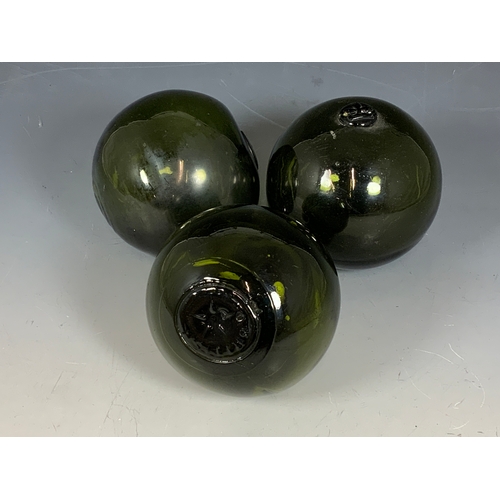 331 - 3 GREEN GLASSS FLOATS, APPROX. 12 CM IN DIAMETER ONE MARKED BRITISH.