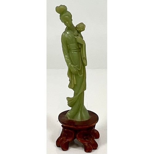 469 - CARVED JADE ORIENTAL LADY MOUNTED ON CARVED WOOD BASE. HEIGHT OF BASE 4cm, HEIGHT OF FIGURE APPROX. ... 