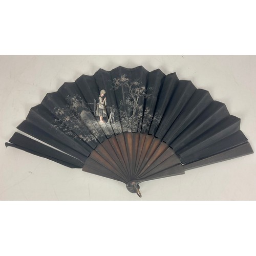 426 - BLACK SILK FAN WITH HAND PAINTED DECORATION DEPICTING A GIRL AND DOG AF IN BUTTONED PADDED BOX