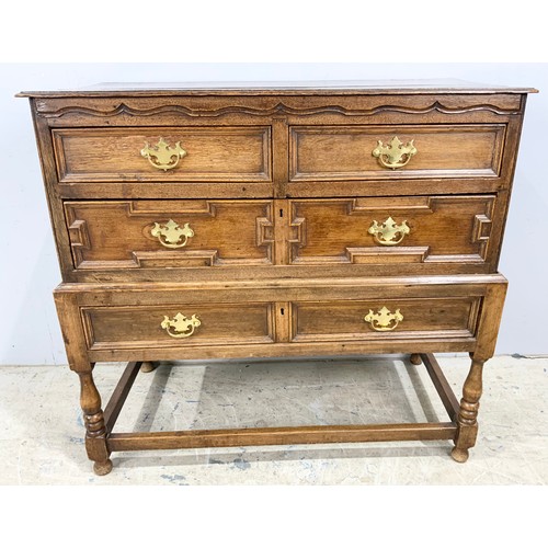 718 - OAK CHEST OF 2 OVER 2 WITH GEOMETRIC MOULDINGS ON STAND WIDTH 102cm