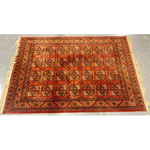 804 - RED GROUND WOOL RUG LABELLED MOSSOW, APPROX. 250 X 170 cm