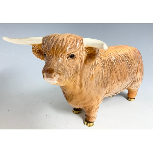 127 - BESWICK MODELS OF A HIGHLAND BULL & A HIGHLAND COW