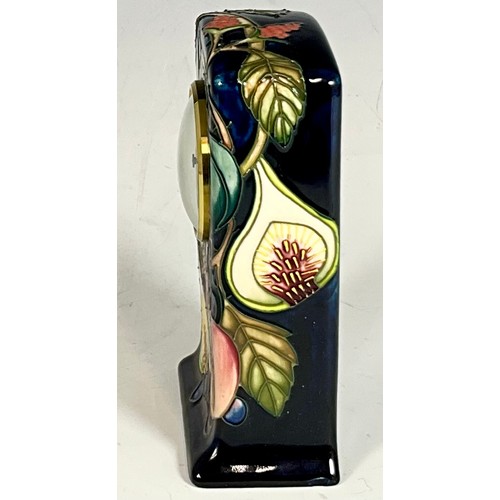 172 - A MANTLE CLOCK IN A MOORCROFT CERAMIC DARK BLUE GROUND CASE SHOWING AUTUMN FRUITS DATED 2000