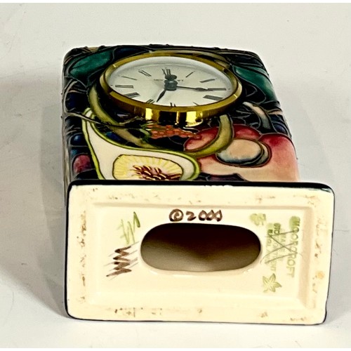 172 - A MANTLE CLOCK IN A MOORCROFT CERAMIC DARK BLUE GROUND CASE SHOWING AUTUMN FRUITS DATED 2000