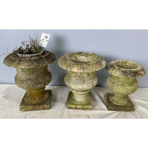 596 - 3 ANTIQUE WEATHERED GRADUATED COMPOSITE GARDEN URNS. TALLEST APPROX. 32cm