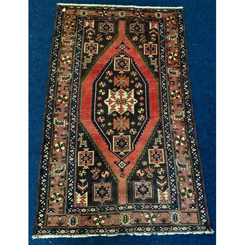 728 - RED GROUND RUG WITH GEOMETRIC PATTERN 210cm x 128cm