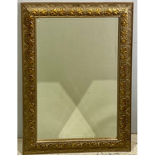 71 - BEVELLED MIRROR WITH ORNATE FRAME. 86 x 55cm