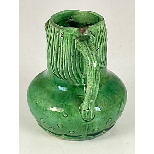 23 - GREEN GLAZED ‘GROTESQUE’ POTTERY JUG, APPROX. 9 cm