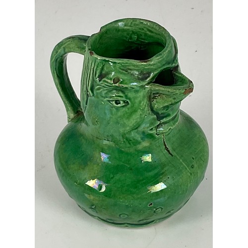 23 - GREEN GLAZED ‘GROTESQUE’ POTTERY JUG, APPROX. 9 cm