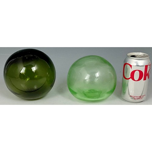 203 - TWO BLOWN GREEN GLASS FISHING FLOATS WITH SEALED PLUGS. LARGEST APPROX. 12cm DIA.