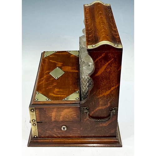 321 - A LATE VICTORIAN OAK CASED TANTALUS AND GAMES BOX