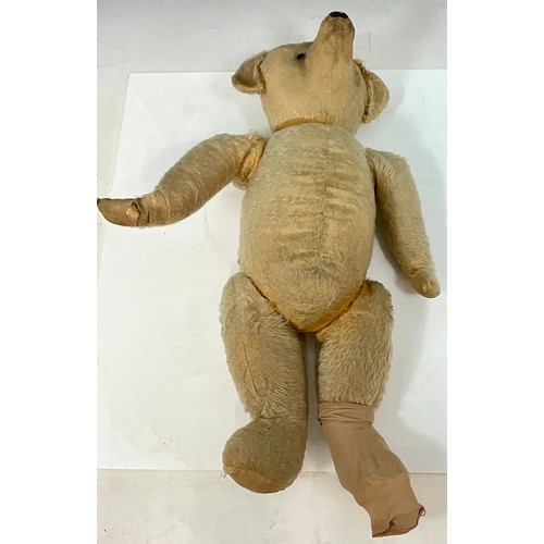 102 - VINTAGE TEDDY BEAR WITH MOVING JOINTS, STITCHED BLACK NOSE, LENGTH APPROX. 67cm. LOSING STUFFING FRO... 