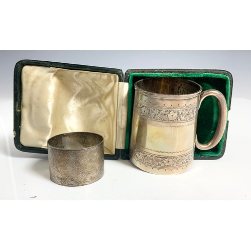 287 - SILVER CHRISTENING TANKARD WITH INSCRIPTION AND A SILVER SERVIETTE RING WITH ENGINE TURNED DECORATIO... 