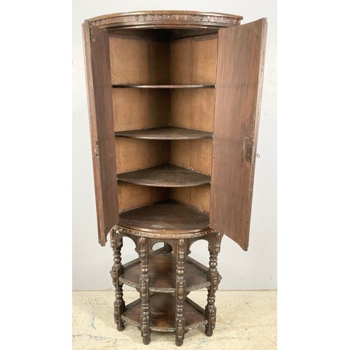 596 - STANDING OAK CORNER CUPBOARD WITH CARVED FLEMISH STYLE DECORATION 170cm TALL