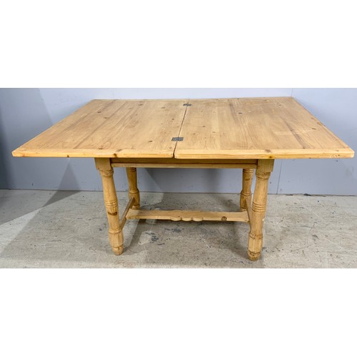 653 - CONTINENTAL FOLDING SWIVEL TOP PINE TABLE ON TURNED LEGS, 99 X 69cm, EXTENDING TO 99 X 138cm