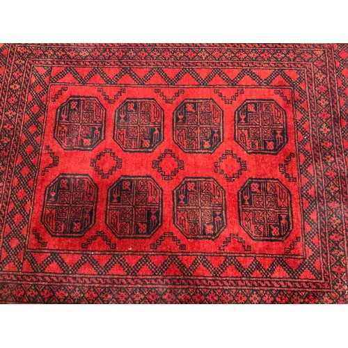 684 - AFGHAN RED GROUND RUG 180cm x 160cm