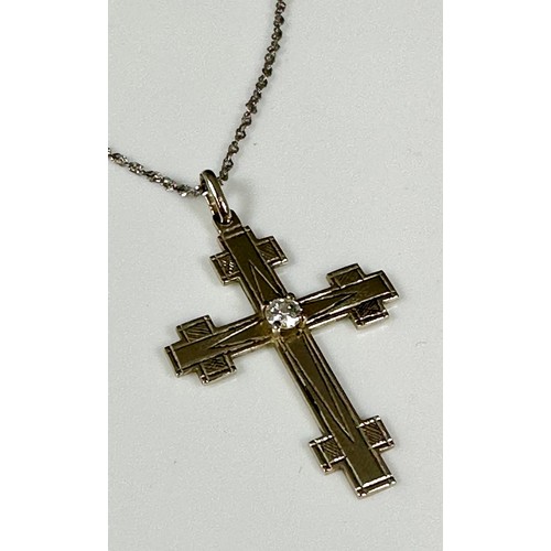 517 - CRUCIFIX ON FINE CHAIN SET WITH A BRILLIANT CUT DIAMOND, APPROX. 20 PTS.