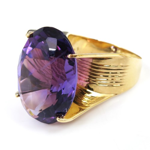 606 - MASSIVE OVAL CUT AMETHYST SET AS A RING ON A 14K 585 BAND, STONE APPROX. 25 X 18 mm