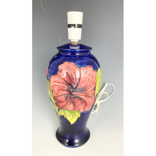 103 - MOORCROFT TABLE LAMP DECORATED IN THE HIBISCUS PATTERN ON BLUE GROUND 34cm TALL