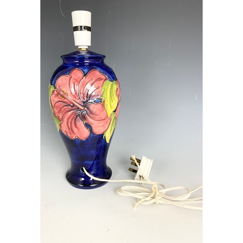 103 - MOORCROFT TABLE LAMP DECORATED IN THE HIBISCUS PATTERN ON BLUE GROUND 34cm TALL